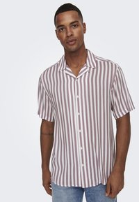 Camisa de botones de manga corta con rayas verticales moradas y blancas, cuello tipo campamento y una textura de tela suave.