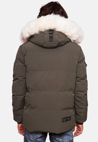 Olive green puffer jacket with a faux fur hood trim, featuring a quilted design, side pockets, and a branded patch on the back.