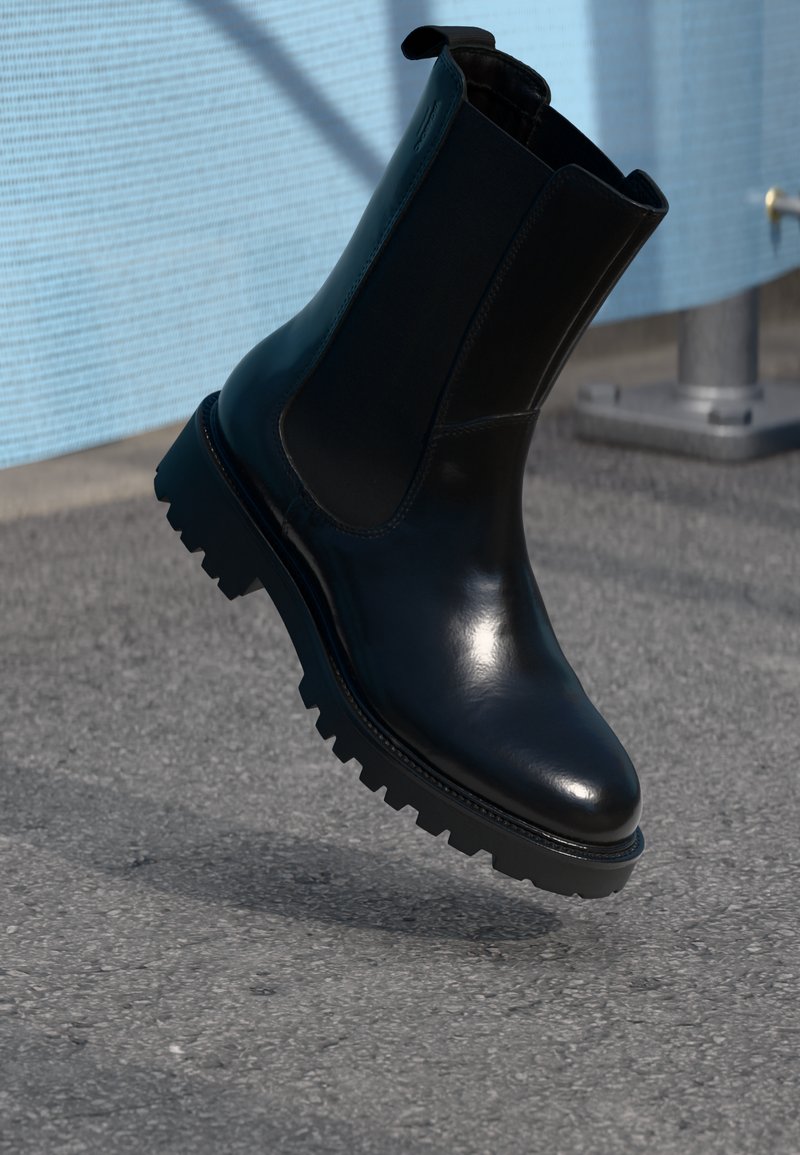 Black leather ankle boot with elastic side panels, textured sole, and a smooth finish. Features a pull tab for easy wear.