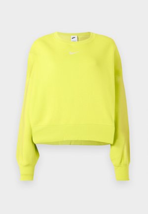 Neón žltý, skrátený sveter s dlhými rukávmi, rebrovanými manžetami a lemom. Obsahuje malé biele logo Nike na hrudi. Mäkká textúra materiálu.