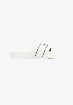 Sandales blanches à glissière avec deux rayures noires sur le dessus, dotées d'une semelle robuste et d'un design simple. Le texte indique "RIPNDIP."