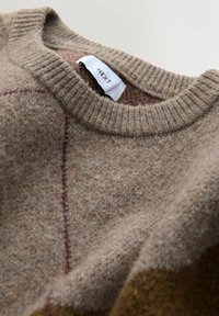 Brown wool sweater with a ribbed crewneck, featuring a subtle plaid pattern in darker hues and a woven texture. Label reads "NEXT."