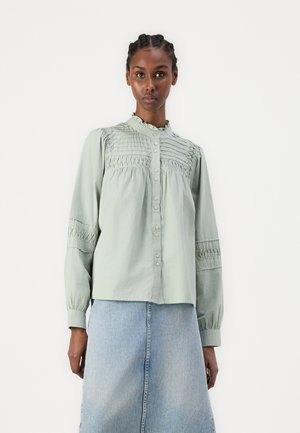 Hellgrünes Hemd mit Knopfleiste und strukturierten Smocking-Details am Oberteil und an den Ärmeln, mit hochgeschlossenem Kragen und lässiger Passform.
