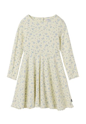 Cremefarvet kjole med lange ærmer, små blå blomsterprint, rund halsudskæring, plisseret nederdel og bølget kant.