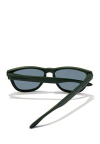 Green sunglasses with a matte finish, rectangular frames, black-tinted lenses, and the brand "HAWKERS" etched on the side.