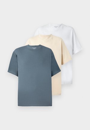 Tre kortærmede t-shirts i blå, beige og hvid, lavet af blød bomuld, med rund halsudskæring og en afslappet pasform.