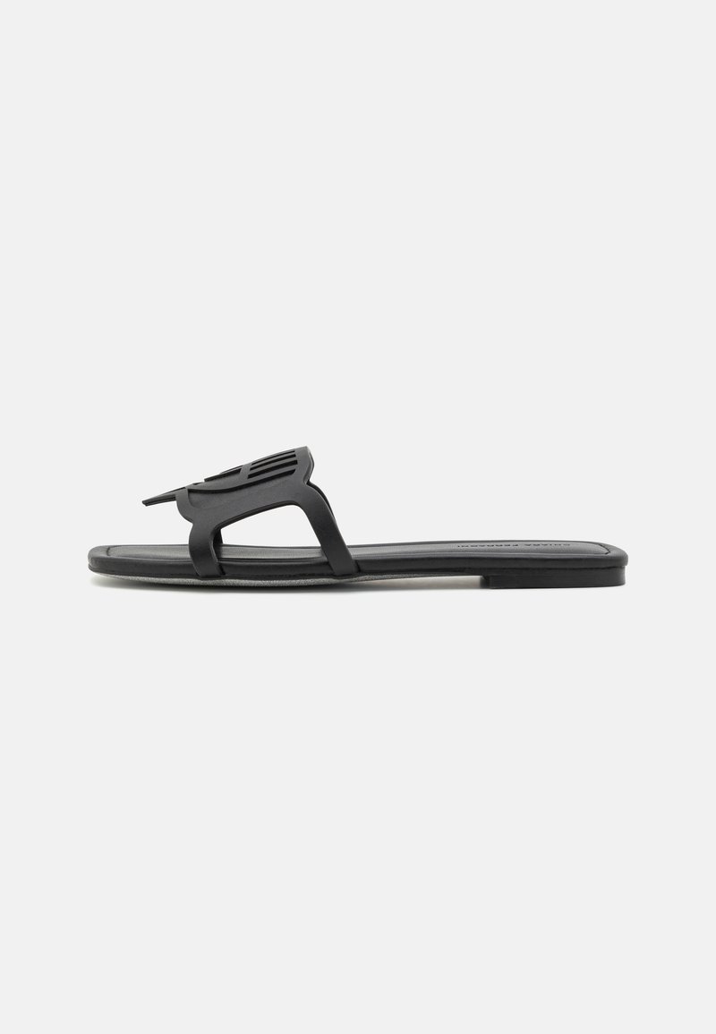 Schwarze flache Sandalen mit einem schlanken Gummidesign, ausgestattet mit einem einzigartigen Ausschnitt-Riemen und einer strukturierten Fußbett für Komfort.