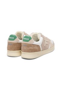 Beige und weiße Sneakers mit einem Obermaterial aus Wildleder und Leder, grünem Fersenakzent und Gummisohle. Logo an der Ferse und an der Seite.