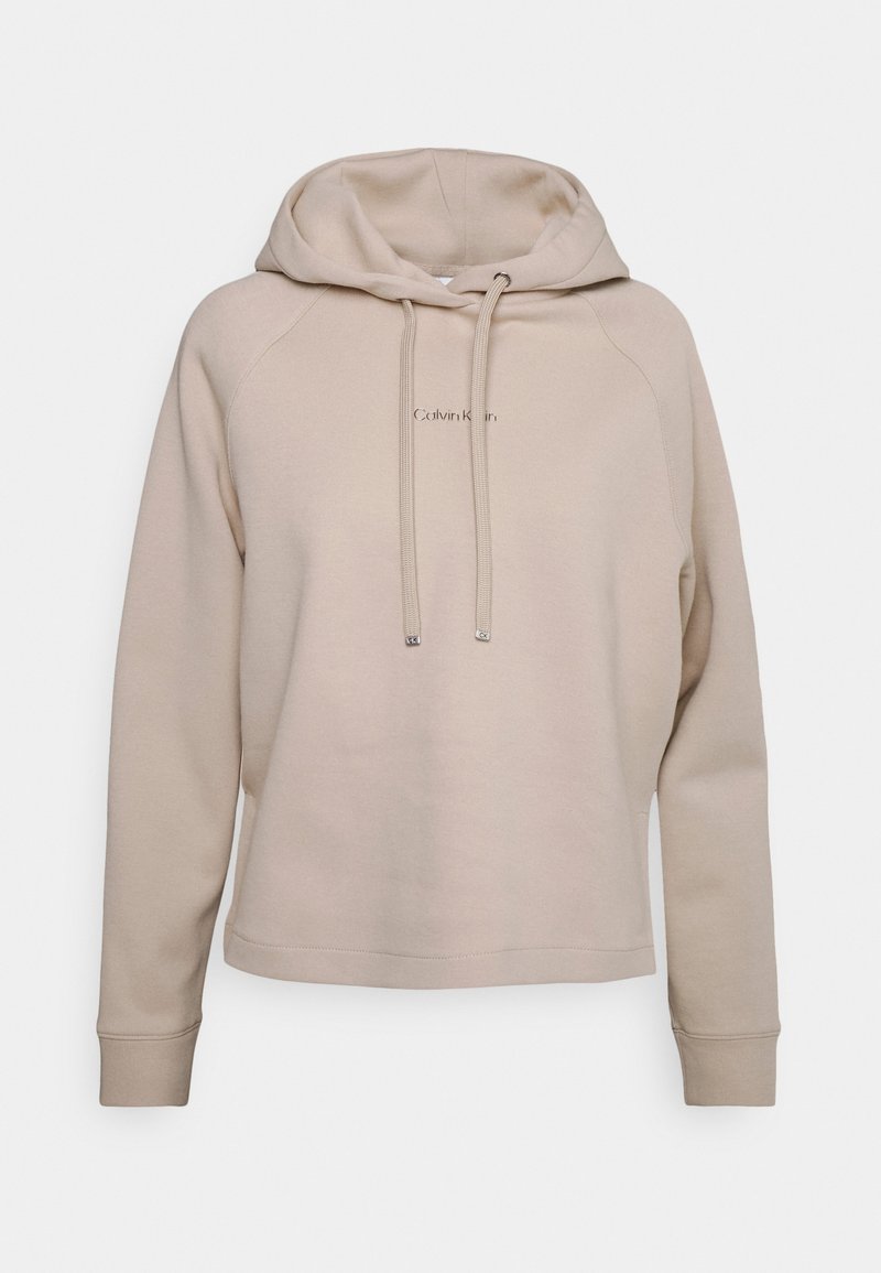 Hoodie beige avec une capuche à cordon, des poignets et un ourlet côtelés. Présente un logo subtil au centre. Matière douce en mélange de coton.