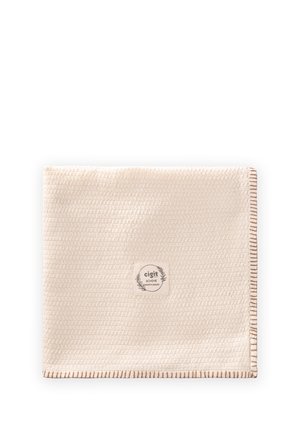 Beige textured fabric square with brown stitched border and a central label reading "cigit BOHEME premium quality" with leaf decoration.