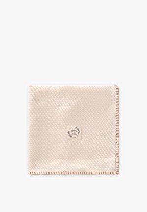 Carré de tissu beige texturé avec une bordure marron cousue et une étiquette centrale portant l'inscription « cigit BOHEME qualité premium » avec une décoration de feuilles.