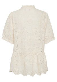 Vit broderad blus med ögla mönster, korta puffärmar, en volangkrage och en scalloped nederkant. Bakåtsikt visas.