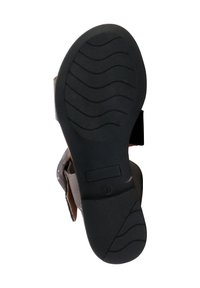 Black rubber sole with textured grooves, featuring a brown upper made of soft material and an adjustable strap for a secure fit.