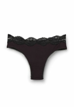 Schwarze Tanga-Unterwäsche mit gerippter Textur, ausgestattet mit einem zarten, gewellten Spitzenbund und -besatz. Für einen minimalen Deckungsgrad entworfen.