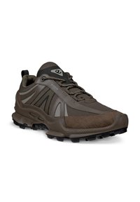 Brown trail running shoes featuring a mix of mesh and textured materials, with a thick rubber sole and prominent grip pattern.