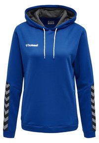 Felpa con cappuccio blu in tessuto texturizzato, con rivestimento grigio a contrasto, lacci bianchi e dettagli a zigzag neri sulle maniche. Logo Hummel visibile.