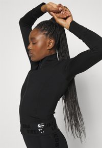 Nebbia NEBBIA WOMEN'S ZIP-UP JACKET INTENSE WARM-UP - Treningsjakke - black