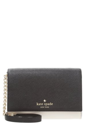 Black and white Kate Spade New York wristlet with gold chain and logo on front, textured leather finish.