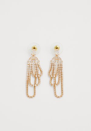 Gold-tone dangle earrings with multiple cascading chains, adorned with clear rhinestones and a transparent backing for secure wear.
