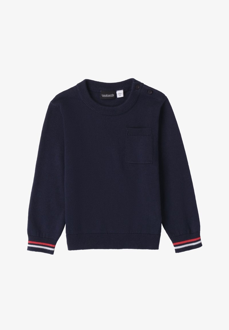 Pull en tricot navy avec un col ras du cou, des manches longues et une poche poitrine avant. Présente des poignets côtelés rayés en rouge et blanc.