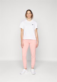 adidas Sportswear ESSENTIALS LINEAR CUFFED - Treniņtērpa apakšdaļas - semi pink spark