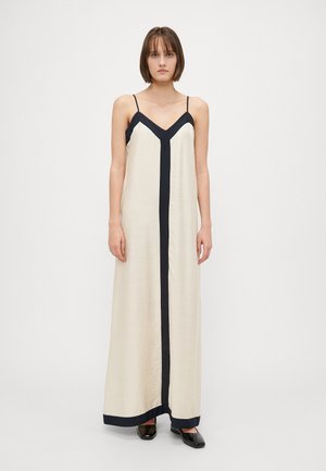 Lichtbeige maxi-jurk met dunne bandjes, met een contrasterende marineblauwe bies langs de V-hals en langs het midden. Glad textuur.