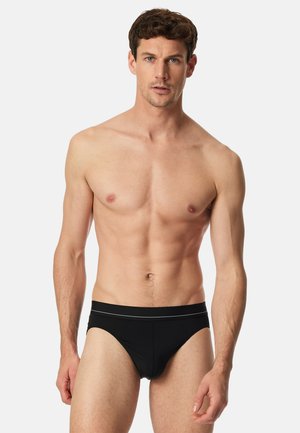 Schwarze Badehose aus glattem, elastischem Material. Verfügt über einen weichen Bund mit silbernem Akzent, der für einen snug fit sorgt.