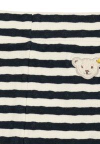 Striped knit fabric in navy and cream with textured polka dots. Features a soft, embroidered bear patch on the left side.