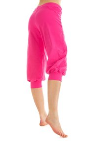Pink capri pants made of soft, stretchy fabric, featuring a fitted cuff at the ankle and a relaxed fit, designed for comfort.