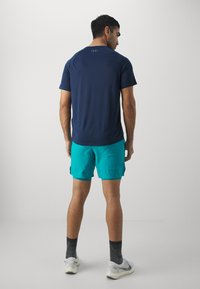 Under Armour LAUNCH - Pantalón corto de deporte - circuit teal