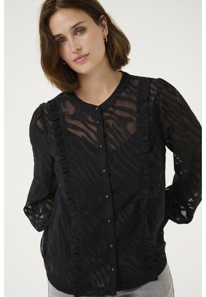 Black sheer blouse with a subtle wavy pattern, ruffled front, round neckline, and button closure. Long sleeves with slightly puffed shoulders.