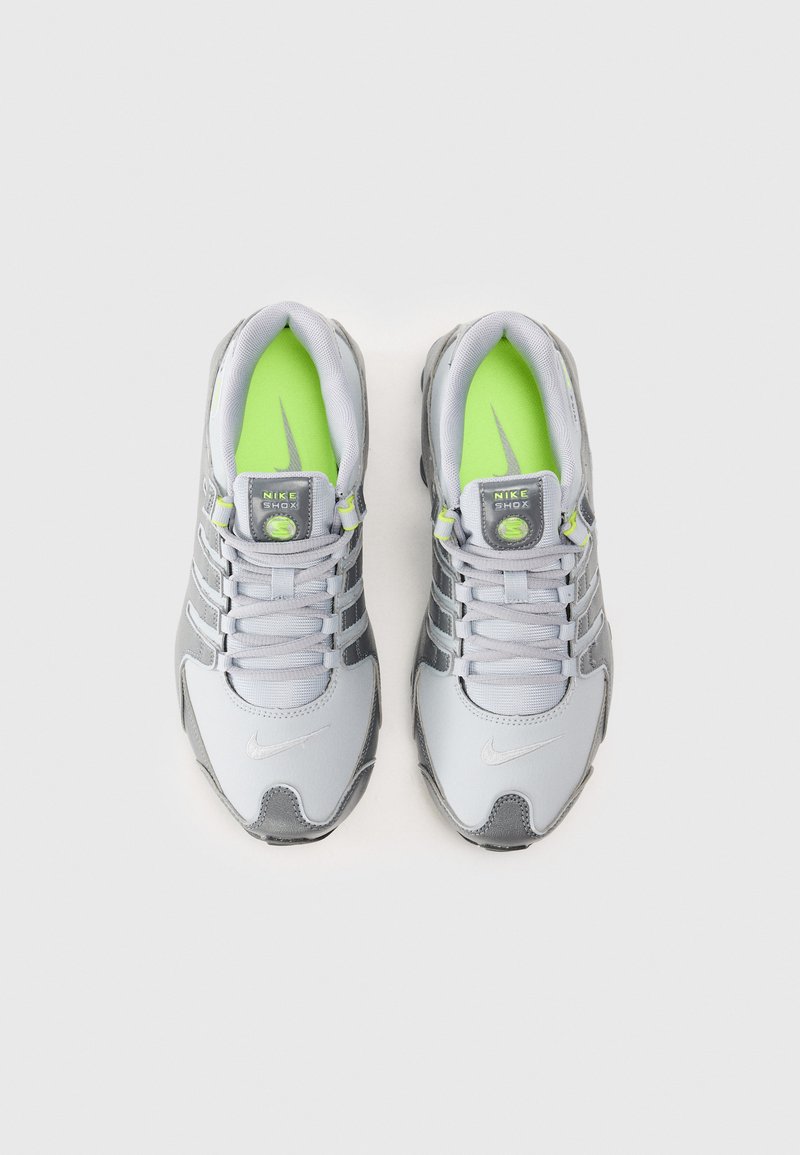 Graue Sportschuhe mit silbernen Akzenten. Verfügen über eine gepolsterte Zunge, ein Obermaterial aus Mesh und Synthetik sowie lebhaft grüne Einlegesohlen. Reflektierende Details sind enthalten.