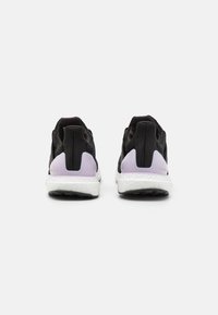 Black athletic shoes with a textured mesh upper, purple accents on the heel, and white cushioned sole, featuring logo detail on the side.