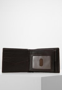 Portafoglio in pelle marrone con più scomparti per carte, un portadocumenti trasparente e una finitura testurizzata. Design pieghevole con uno stile minimalista.