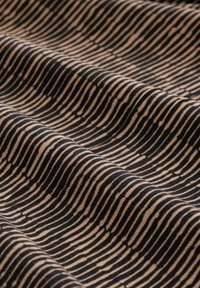 Black and cream fabric featuring horizontal stripes with varied widths, displaying a smooth texture and a subtle sheen.