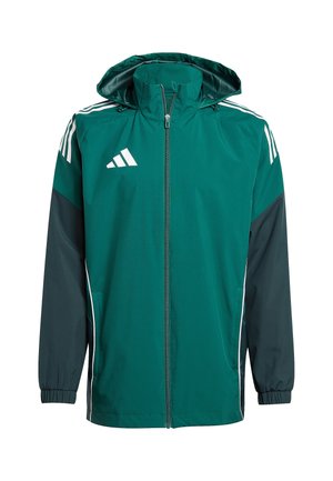Veste coupe-vent vert et marine avec capuche, fermeture éclair, poignets élastiques, rayures blanches sur les épaules et poches latérales.