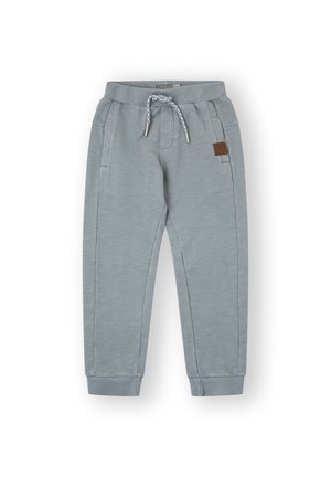 Pantalones de chándal grises con cinturilla elástica, cordón ajustable, bolsillos laterales, puños estrechos y un parche de cuero marrón.