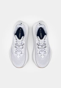 Baskets blanches avec tige en mesh et synthétique, bout arrondi, système de laçage, semelle rembourrée et marquage "FORMFIT" sur la semelle intérieure bleue.