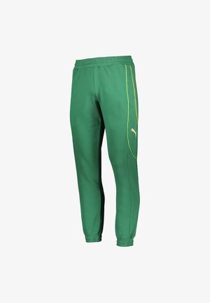 Groene katoenen joggers met een elastische tailleband en boorden. Voorzien van gele zijstrepen en een klein gouden logo op het linkerbeen.