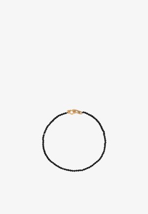 Schwarzes Perlenarmband mit kleinen runden Perlen und einem goldenen Verschluss, der mit einem dezenten Design verziert ist. Einfach, leicht und zart.