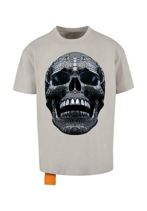 Gray t-shirt featuring a large black and silver skull graphic on the front, with an orange tag at the bottom left corner.