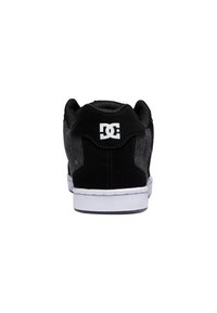 Black skate shoe with a textured grey back panel, white sole, and prominent logo on heel. Features padded collar and smooth finishing.