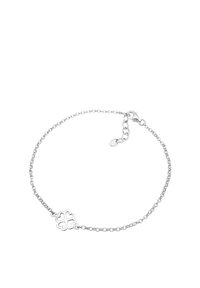 Söderkedja armband med en central fyrklöverdesign, med rundade kanter och karbinlås, som visar en slät yta.