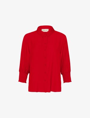 Czerwona bluzka zapinana na guziki z kołnierzykiem, długimi bufkami i marszczonymi mankietami, wykonana z gładkiego materiału. Posiada luźny krój i elegancki design.
