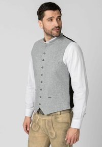 Gray wool vest with a mandarin collar, featuring a front pocket, silver buttons, and black side panels, worn over a white shirt and trousers.