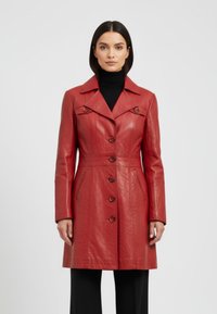 Red leather coat with a collared neckline, button front, and two side pockets. Features stitched detailing and a fitted silhouette.