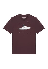 Bordeaux katoenen t-shirt met een witte afbeelding van een zittende astronaut op een papieren vliegtuigje, omringd door kleine sterren. Korte mouwen.