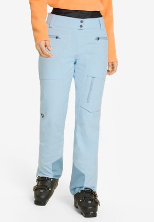 Light blue waterproof ski pants with multiple pockets, black zippers, and reinforced cuffs. Features a relaxed fit and durable material.