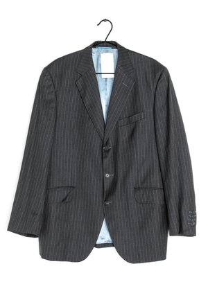 Black pinstriped blazer with two front pockets, single-breasted design, three buttons, and a light blue lining. Hangs from a black hook.