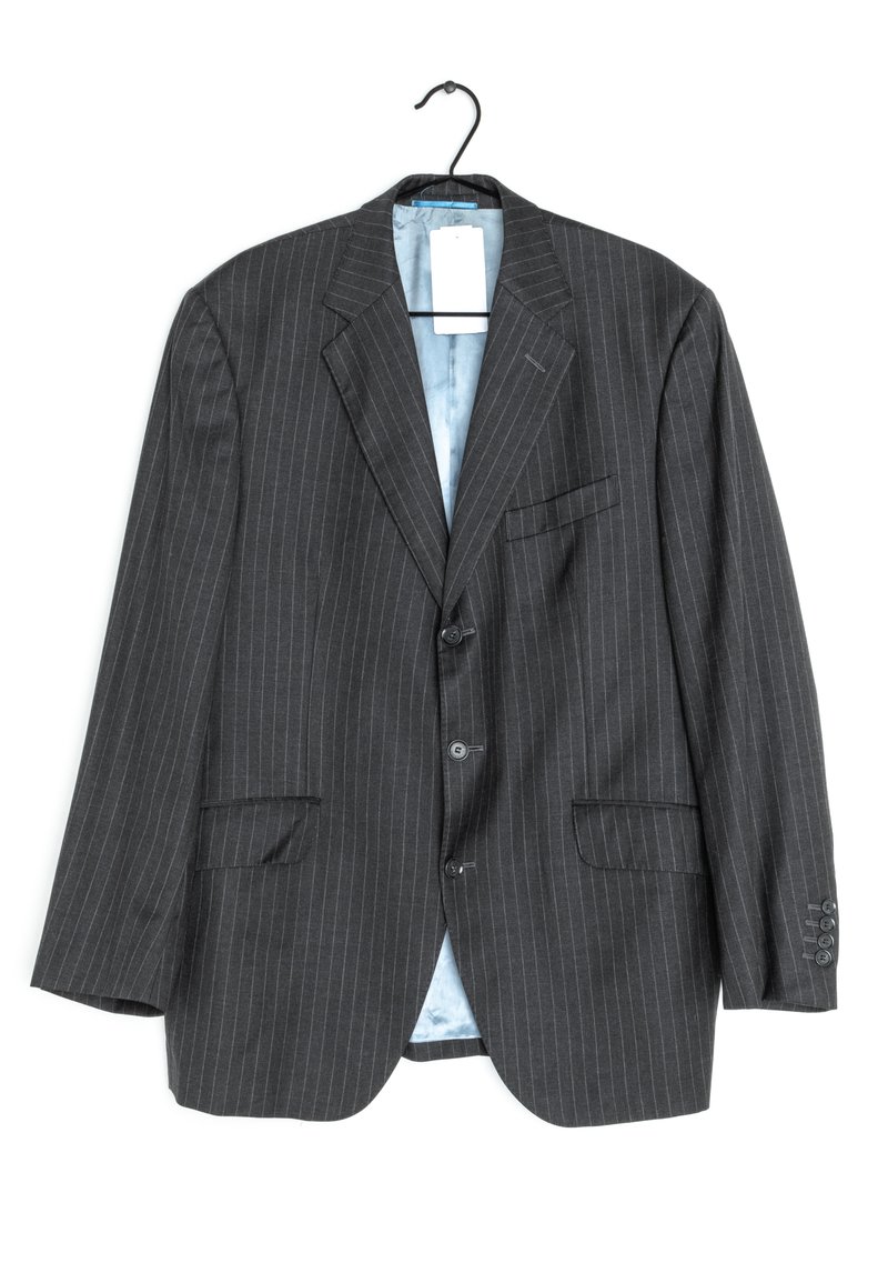 Black pinstriped blazer with two front pockets, single-breasted design, three buttons, and a light blue lining. Hangs from a black hook.